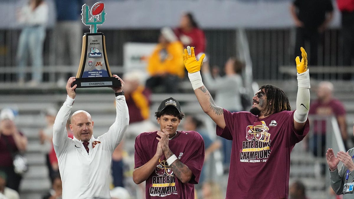 PJ Fleck raises the Rate Bowl trophy