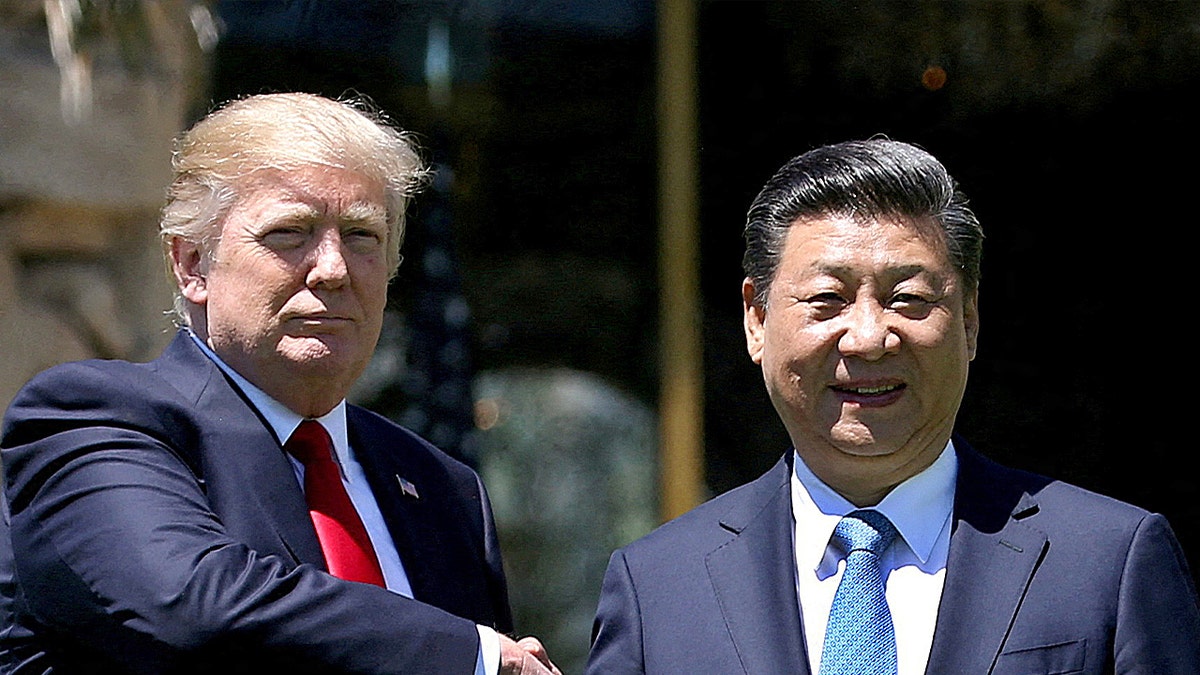 U.S. President Donald Trump (L) and China's President Xi Jinping shake hands while walking at Mar-a-Lago estate after a bilateral meeting in Palm Beach, Florida, U.S., April 7, 2017.