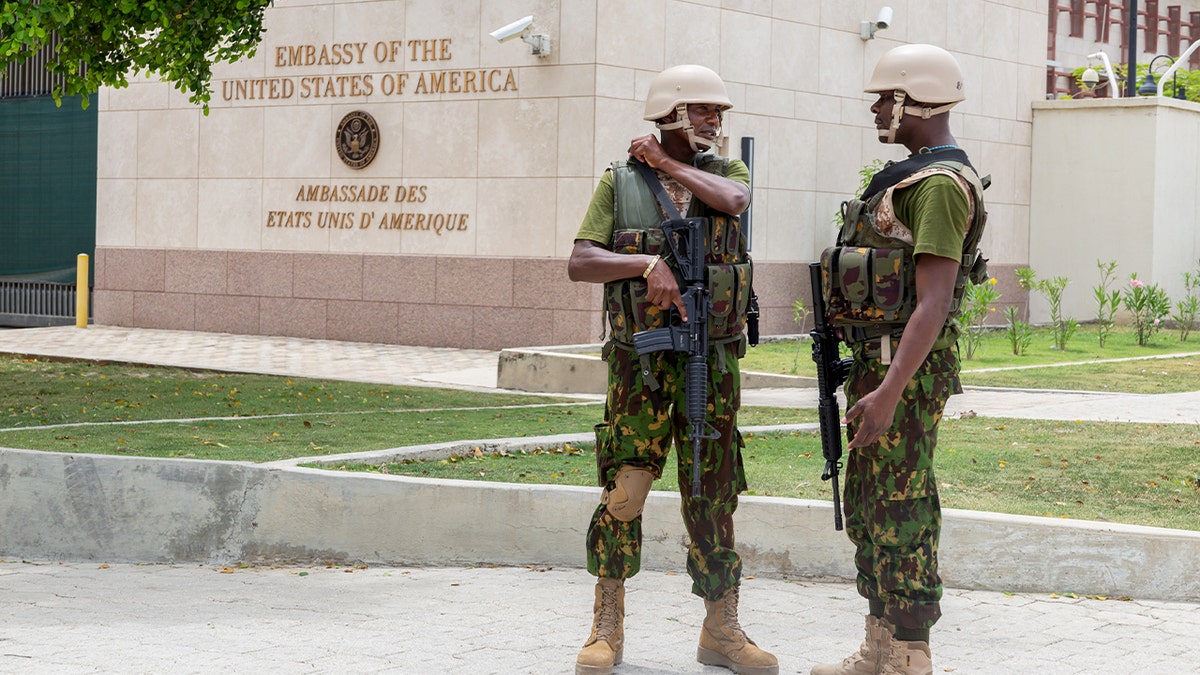 Kenyan police officers guard the perimeter of a foreign embassy building in Haiti.