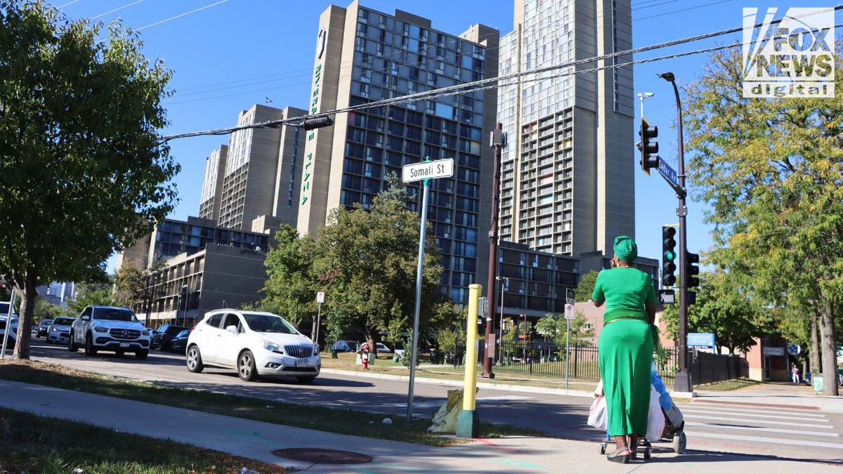 Somali Street sign with Riverside Plaza buildings behind it in Minneapolis