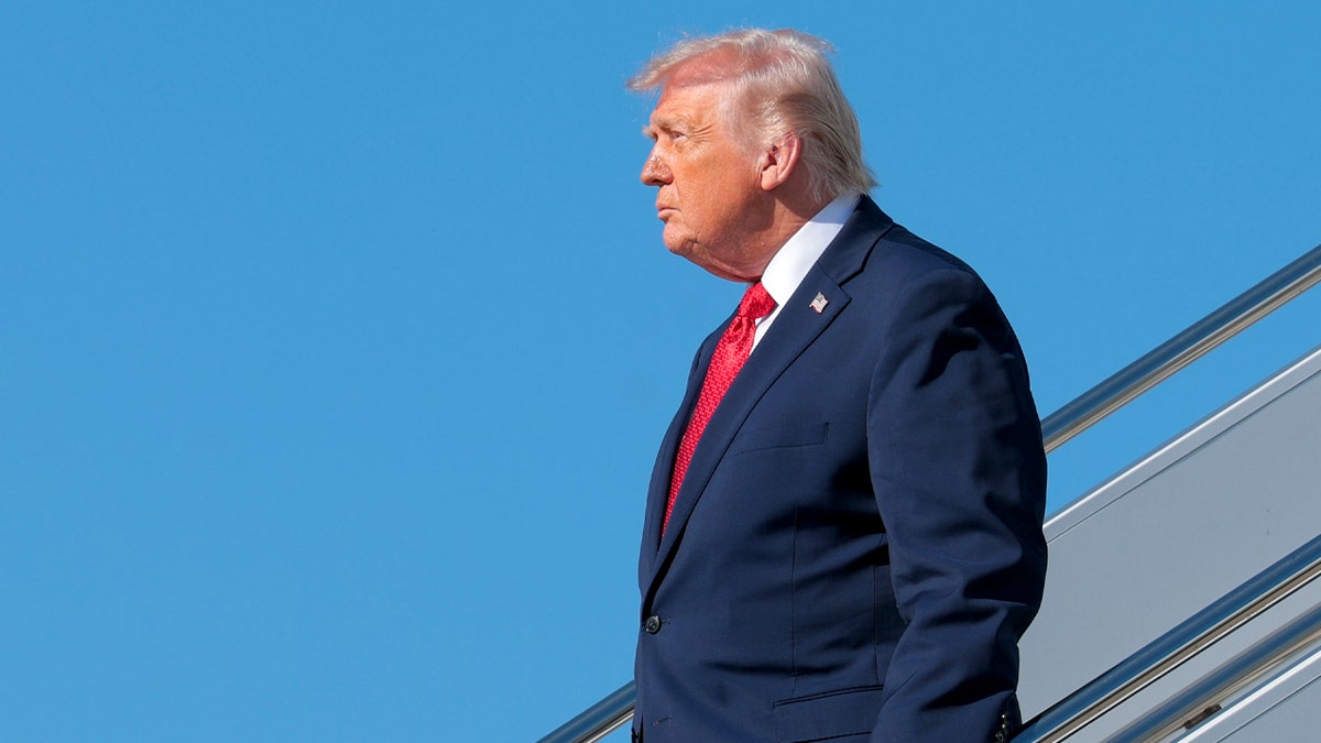 Donald Trump steps off Air Force One onto the airport tarmac in Florida.