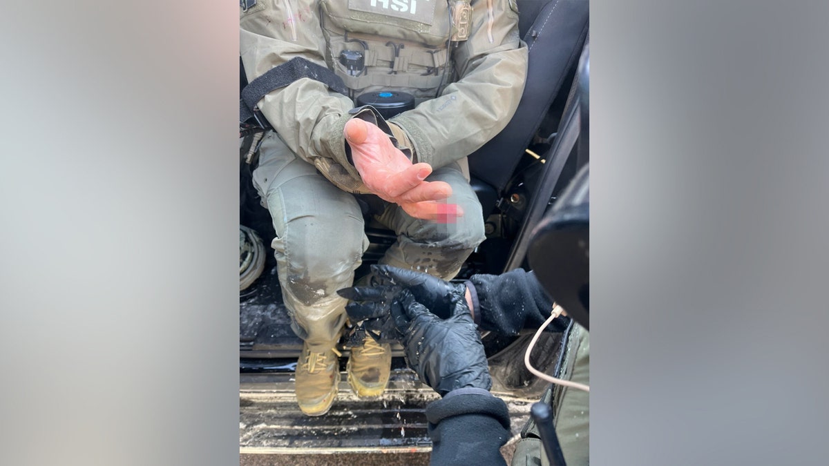 A blurred finger of an federal agent.