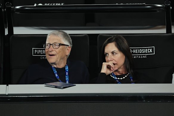 Bill Gates and Paula Hurd watch on Rod Laver Arena during the men’s doubles final, 