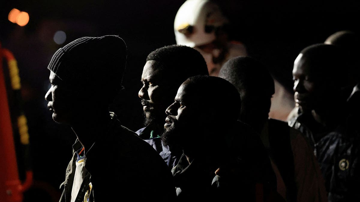 Migrants wait to disembark at the port of Arguineguin after being rescued by a Spanish Coast Guard vessel, on the island of Gran Canaria, Spain