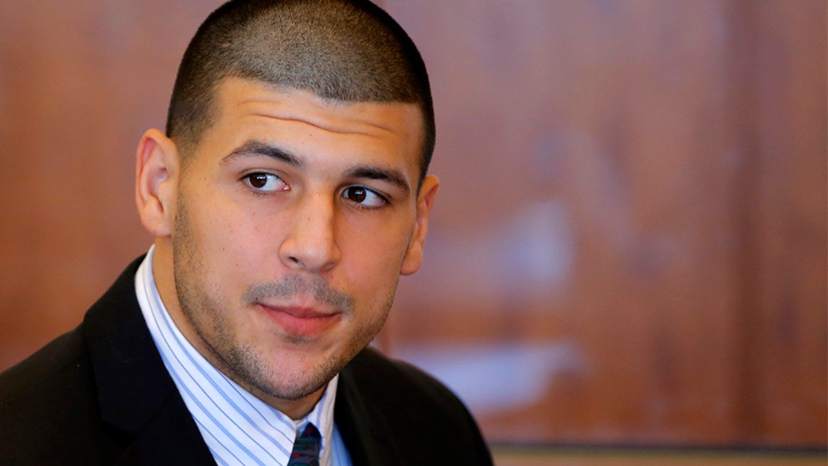 Aaron Hernandez, former player for the NFL's New England Patriots football team, attends a pre-trial hearing at the Bristol County Superior Court in Fall River, Massachusetts October 9, 2013, in connection with the death of semi-pro football player Odin Lloyd in June. Hernandez, who was a rising star in the NFL before his arrest and release by the Patriots, has pleaded not guilty. REUTERS/Brian Snyder (UNITED STATES - Tags: CRIME LAW SPORT FOOTBALL HEADSHOT) - GM1E9AA0A1401