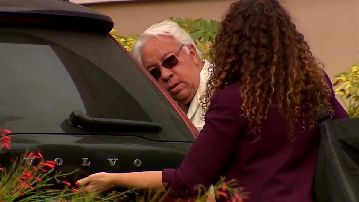 Carlos Guillermo Alonso is seen exiting a vehicle with his attorney.