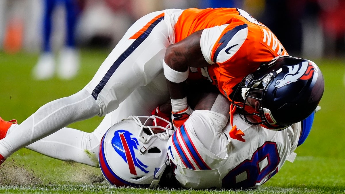 Denver Broncos cornerback Ja'quan McMillian intercepts a pass intended for Buffalo Bills wide receiver Brandin Cooks during overtime at Empower Field at Mile High.