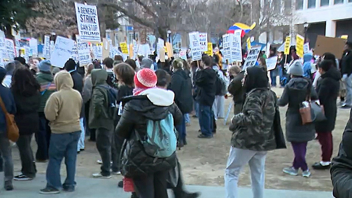 protestors holding signs outside 