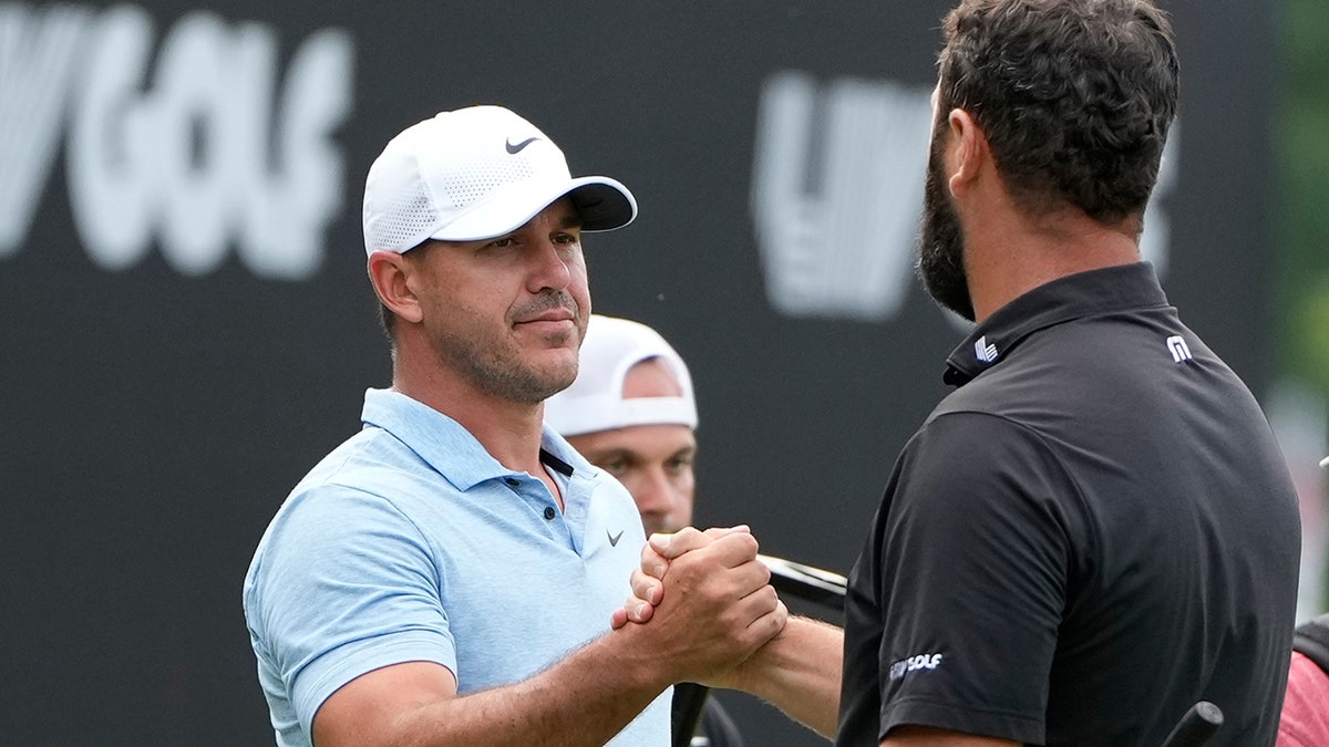 Brooks Kopeka and Jon Rahm shake hands