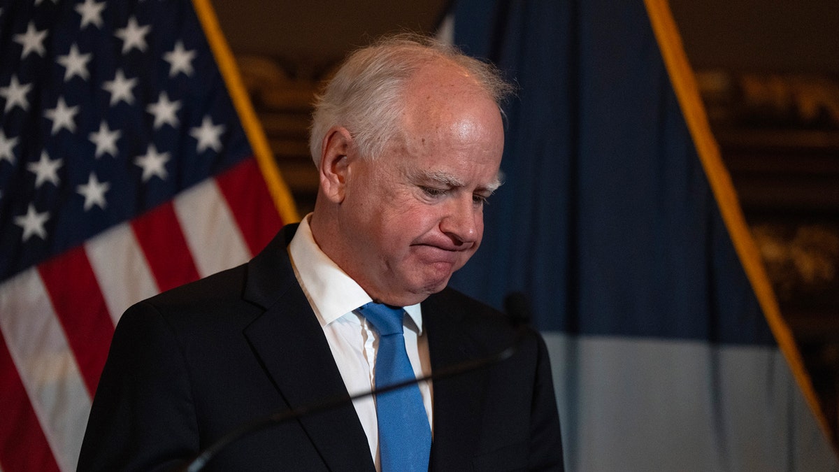 Tim Walz looks at the floor