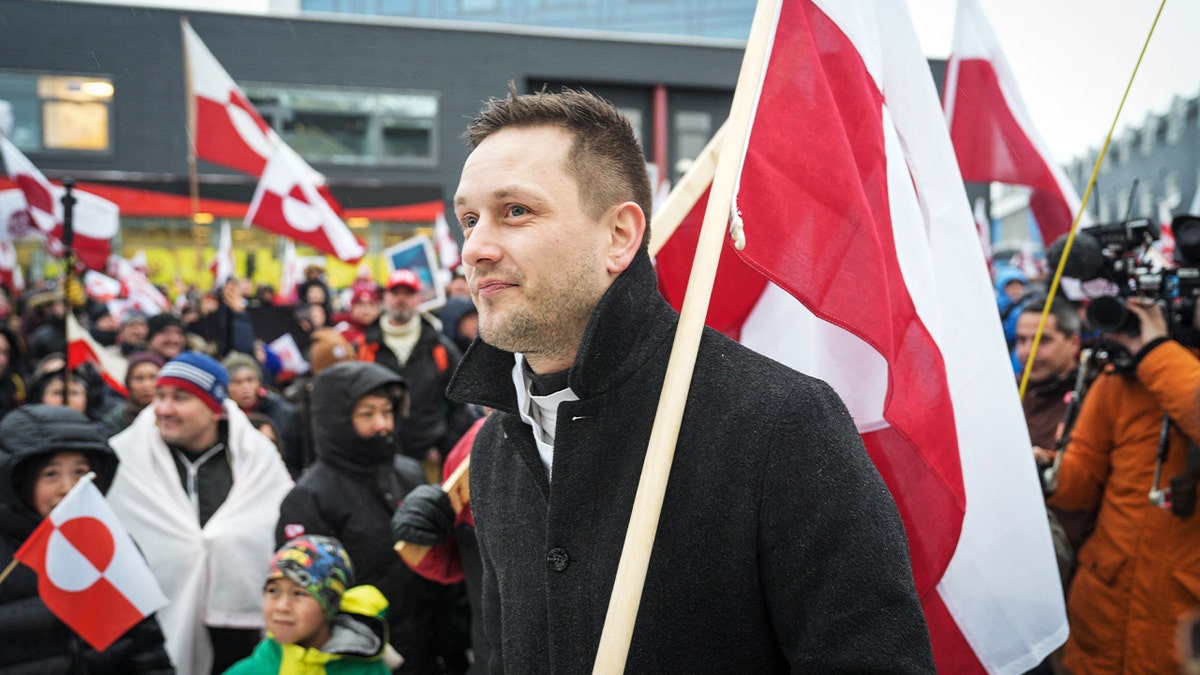 Greenland’s prime minister walks among protesters in Nuuk opposing foreign ownership of the Arctic island.