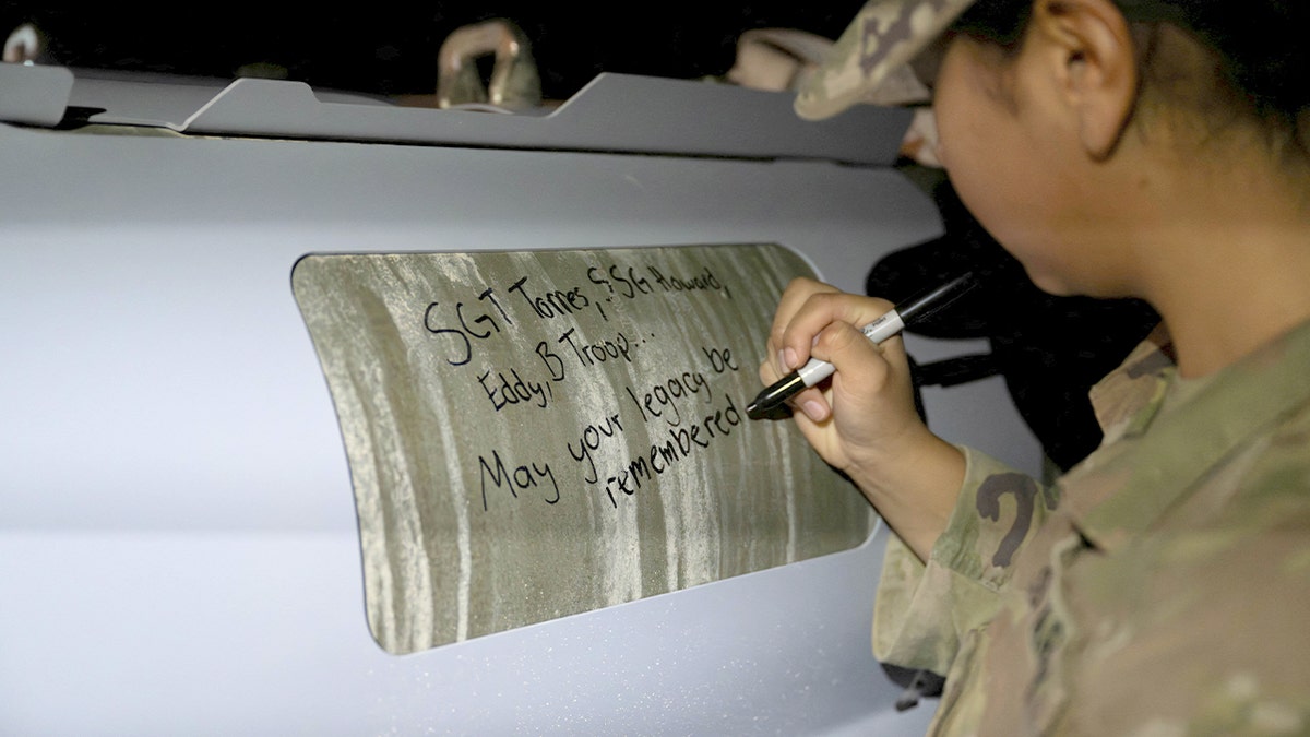 U.S. soldiers attached to the Iowa National Guard sign GBU-31 munitions systems