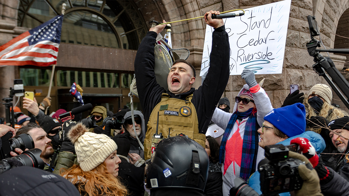 Influencer Jake Lang is confronted by protesters at a rally near city hall on January 17, 2026 in Minneapolis, Minnesota.