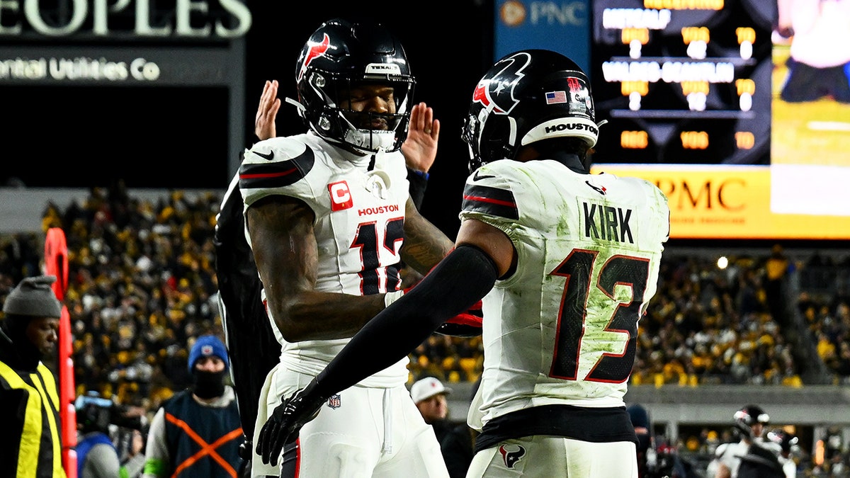 Nico Collins and Christian Kirk celebrate