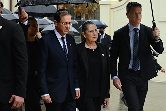 Israeli President Isaac Herzog (left) and his wife Michal Herzog (centre) with NSW Premier Chris Minns (right) during their visit to Bondi Pavilion.