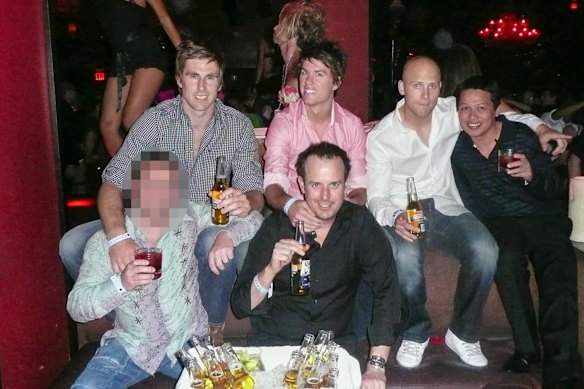 Stuart Coffield (front centre wearing black shirt) and Sy Giang Nguyen (right wearing black shirt) with Geelong footballers (left to right) Tom Lonergan, Andrew Mackie and Gary Ablett Jr in Las Vegas in 2009. 