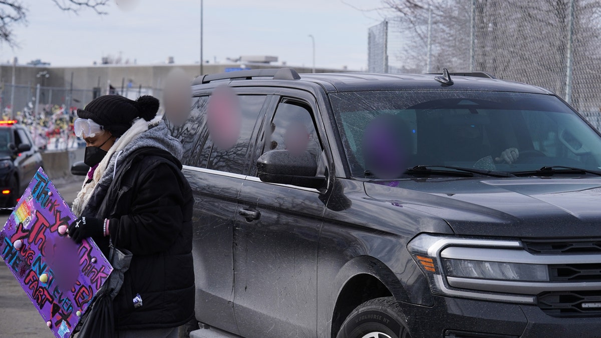 Protest photo with blurred out profanity