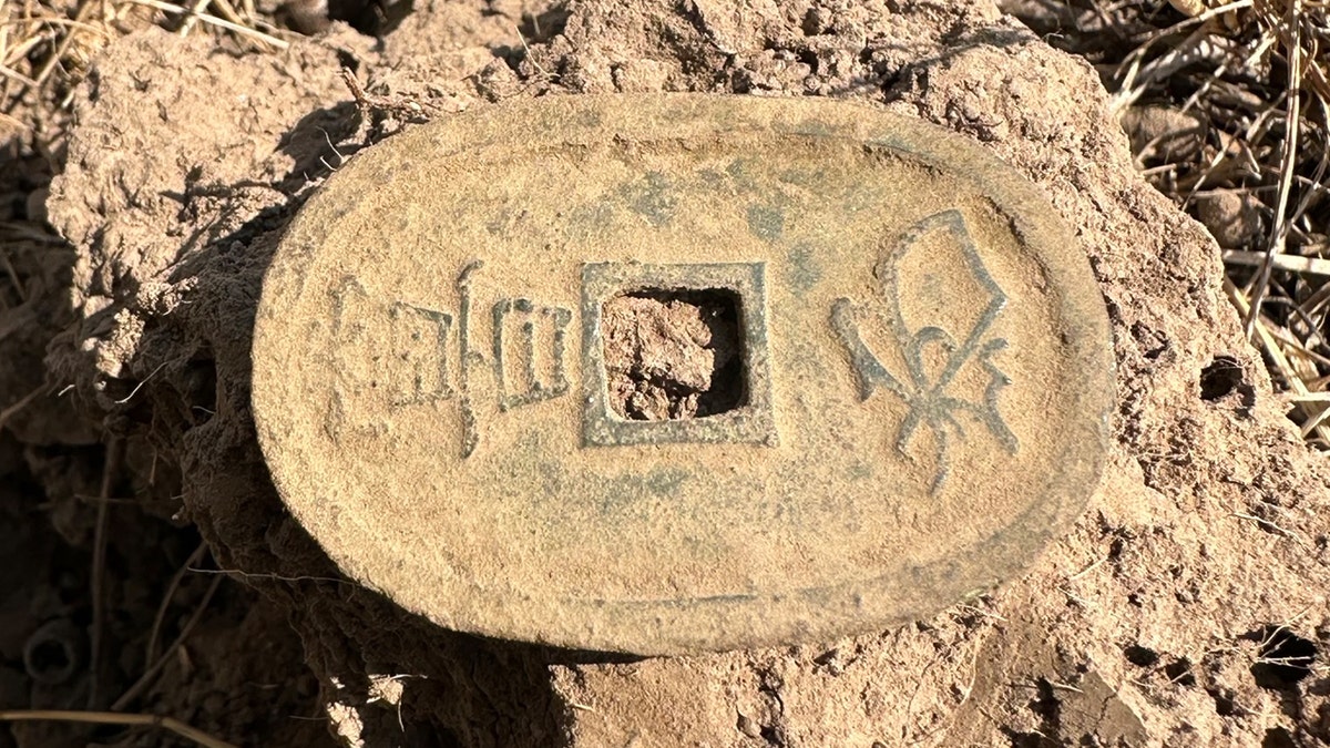 Japanese coin in dirt