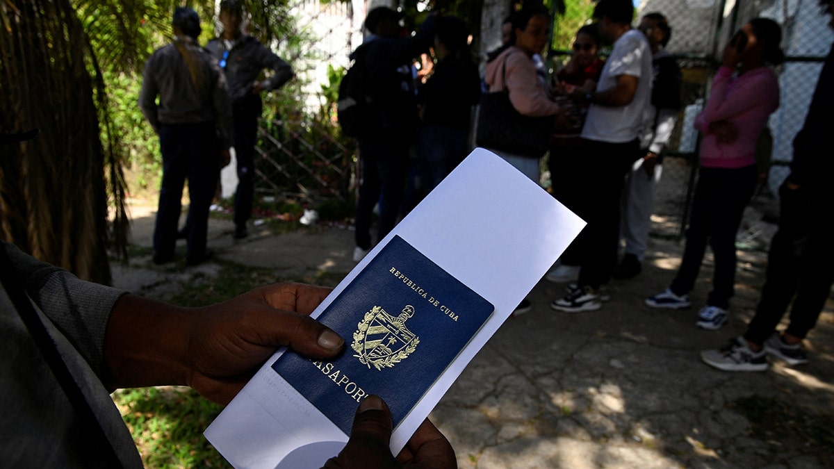 Man holds passport outside Nicaraguan Embassy