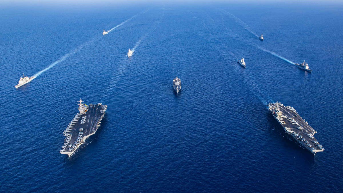 USS Gerald R. Ford at sea with other aircraft carriers
