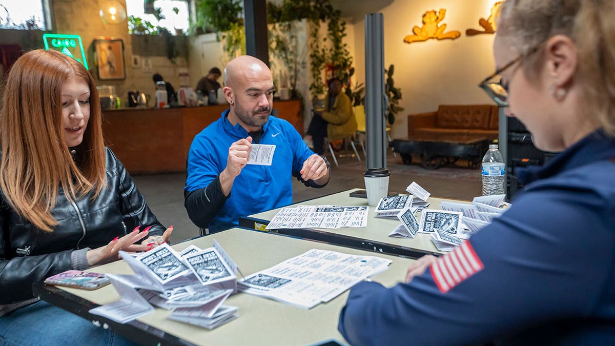 Volunteers assemble anti-ICE whistle kits in Detroit.