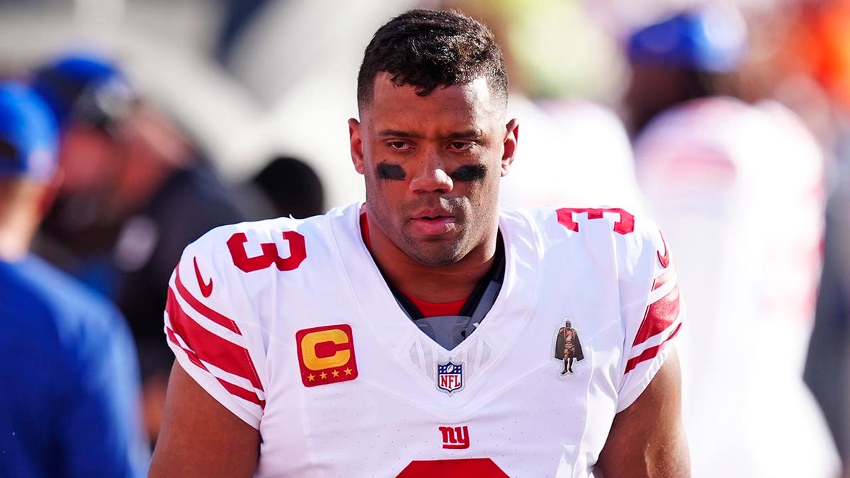 Russell Wilson walks the sideline in Denver