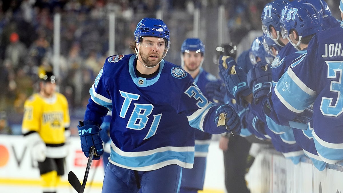 Brandon Hagel shakes hands with his teammates