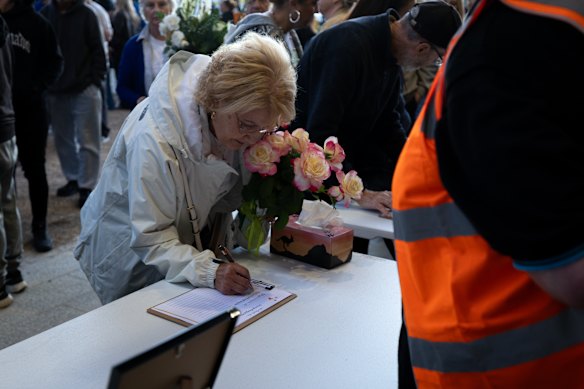 A condolence book is signed at the Mernda vigil.