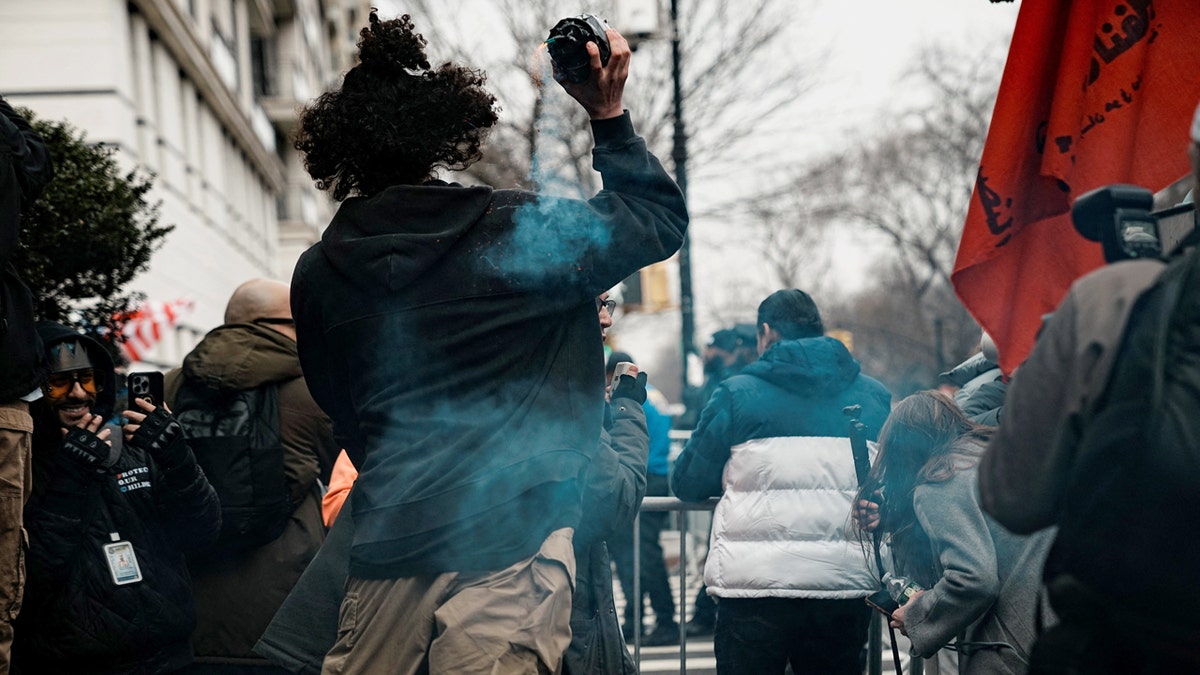 A man appearing to throw a hand-made explosive device into a crowd