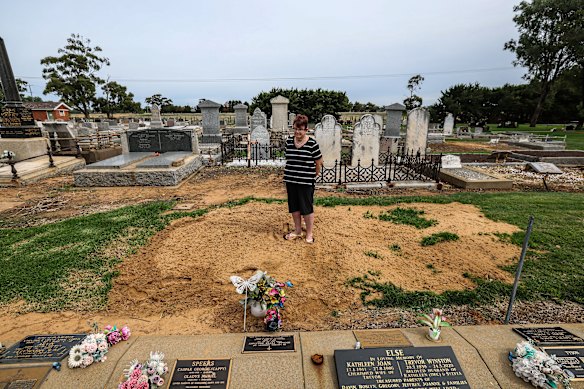 Glenys at the graveside of her husband Brian and son Michael.