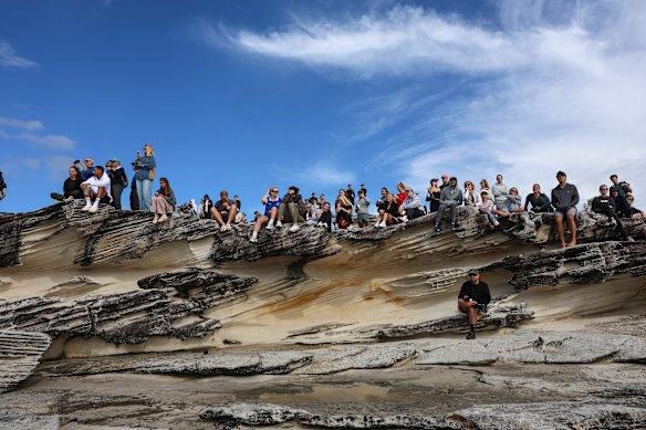 Crowds look out to the wild ocean from Trenerry Reserve.