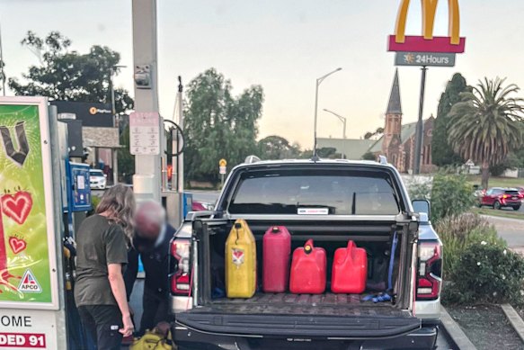 Motorists fill jerry cans for fear of fuel supplies running out.