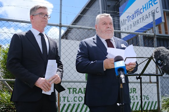 Counsel assisting the Queensland Commission of Inquiry into the CFMEU and Misconduct in the Construction Industry, Patrick Wheelahan KC, (left) and Commissioner Stuart Wood, KC, holding an unusual media conference outside a Gold Coast traffic management firm last week.