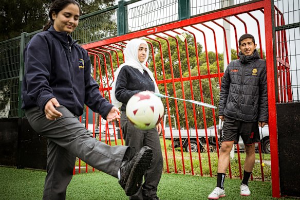 Lana Faytrouni, 15 (left), and Aya Alhadloush, 17, take part in the Kick ‘N’ Mix program with coach Ramadan Aldana. 