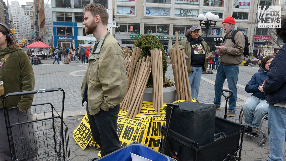 Members of the ANSWER Coalition setting up banners and signs in Union Square.