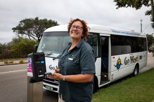 Go West tour guide Jools De Loryn pays for parking near the Brighton Bathing Boxes.