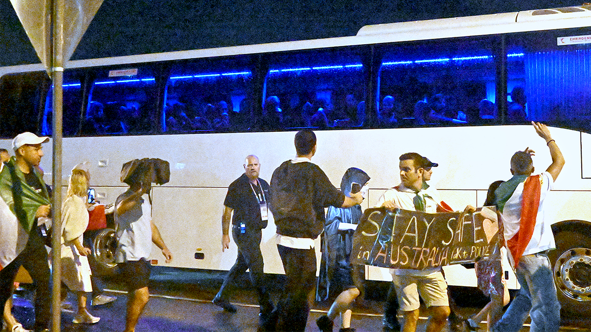 Supporters near a bus with Iran's soccer players