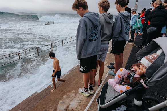 Crowds gathered to watch the waves at Dee Why rock pool on Saturday morning. 