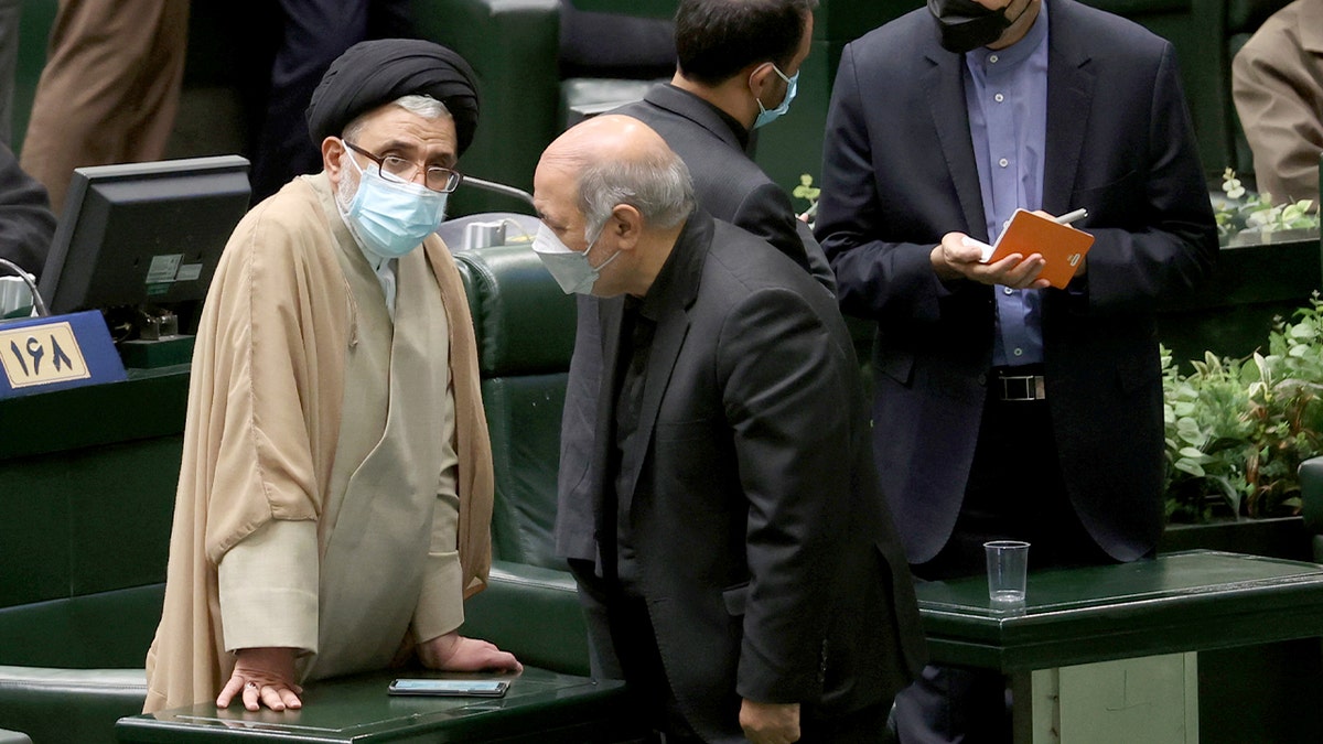 Iranian nominees Hossein Amir Abdollahian and Esmaeil Khatib sit among lawmakers during a parliamentary session in Tehran.