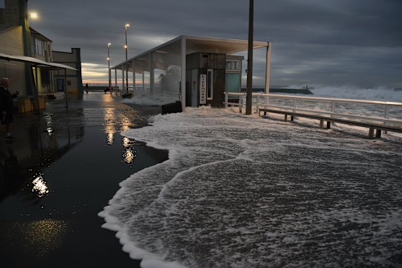 The large swell hit Newcastle early this morning, including at Bar Beach where the Cooks Hill Surf Club took a battering.