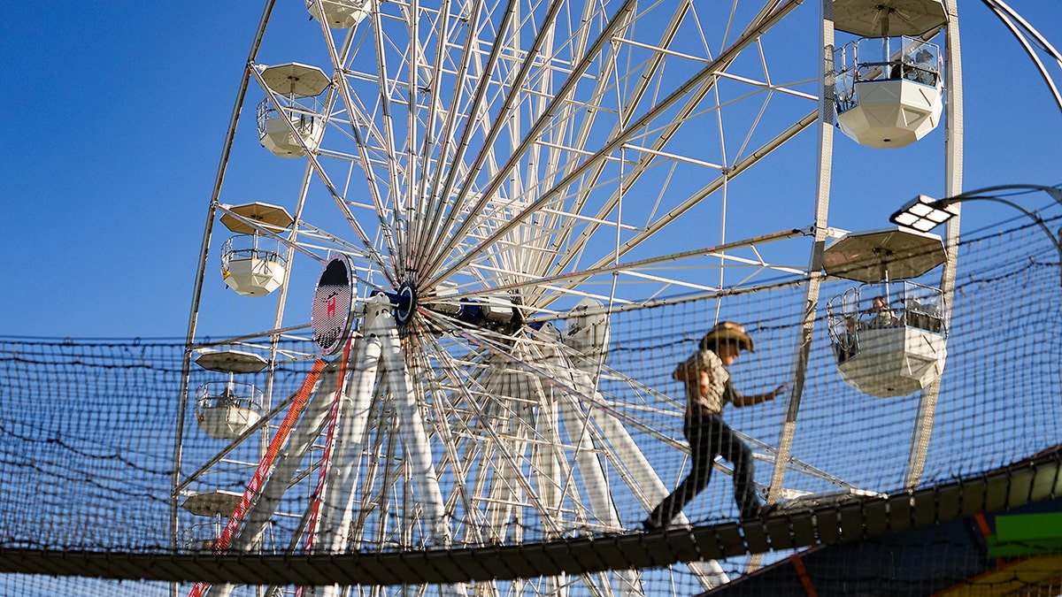 Person walks on Houston Livestock Show and Rodeo obstacle course