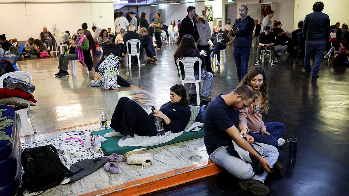People take shelter in parking lot in Tel Aviv, Israel