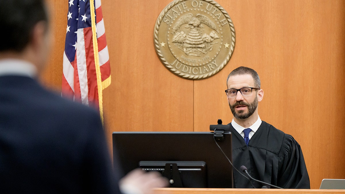 Richard Mrazik and Brad Bloodworth speaking to each other in a courtroom.