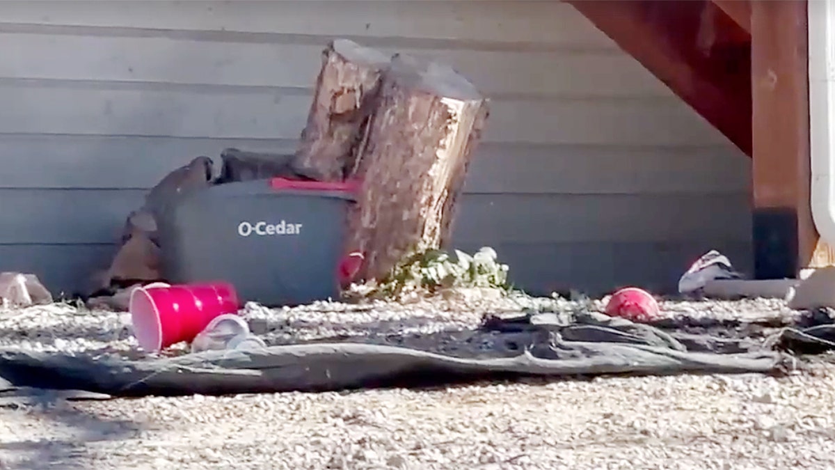 Red plastic cups and debris outside a residence near Northern Arizona University following a fraternity hazing investigation.