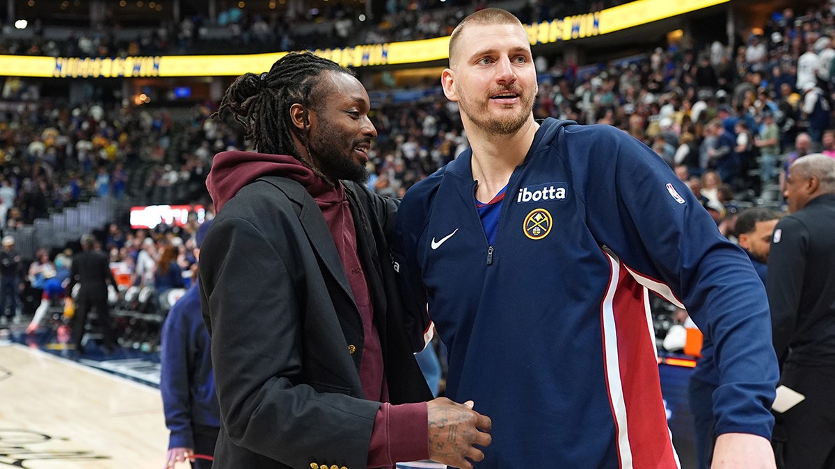 Nikola Jokic greets a player
