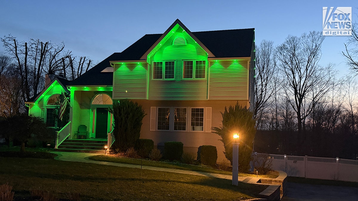 Sheridan Gorman is honored with green light bulb glowing on a porch of a residential home at night