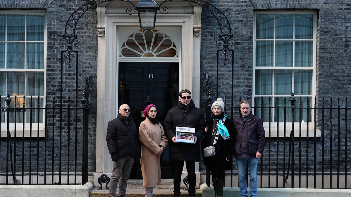 Son of craig and lindsay foreman with petition in front of 10 Downing