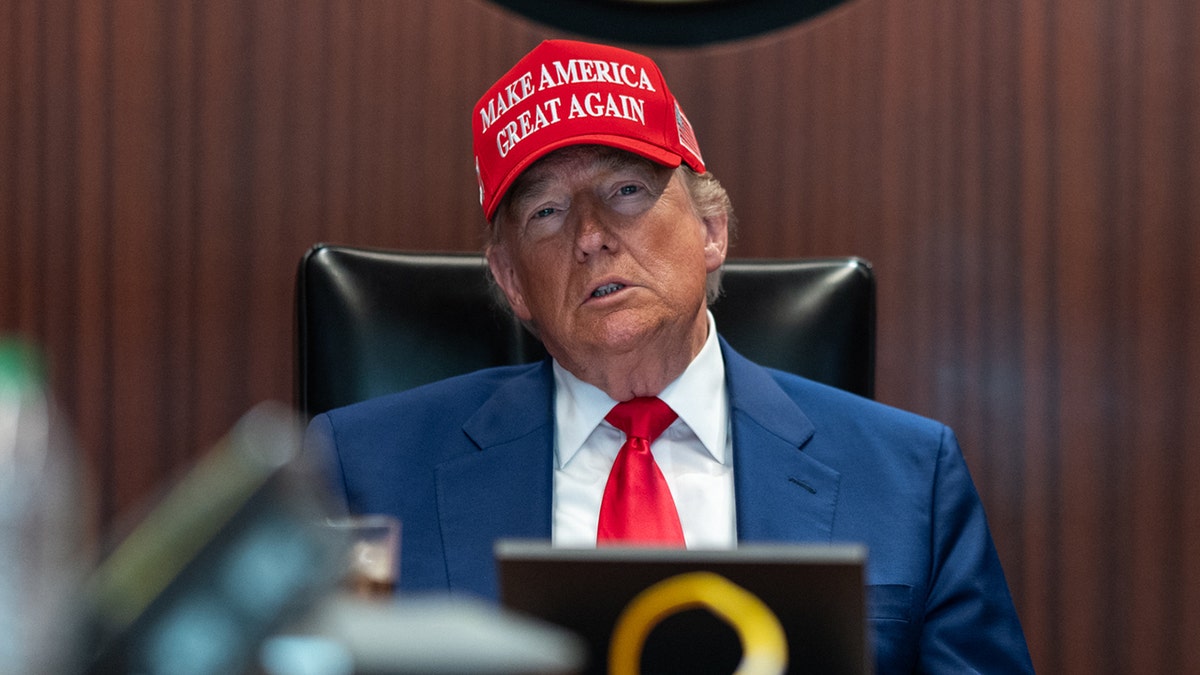 Trump in the Situation Room with a MAGA hat