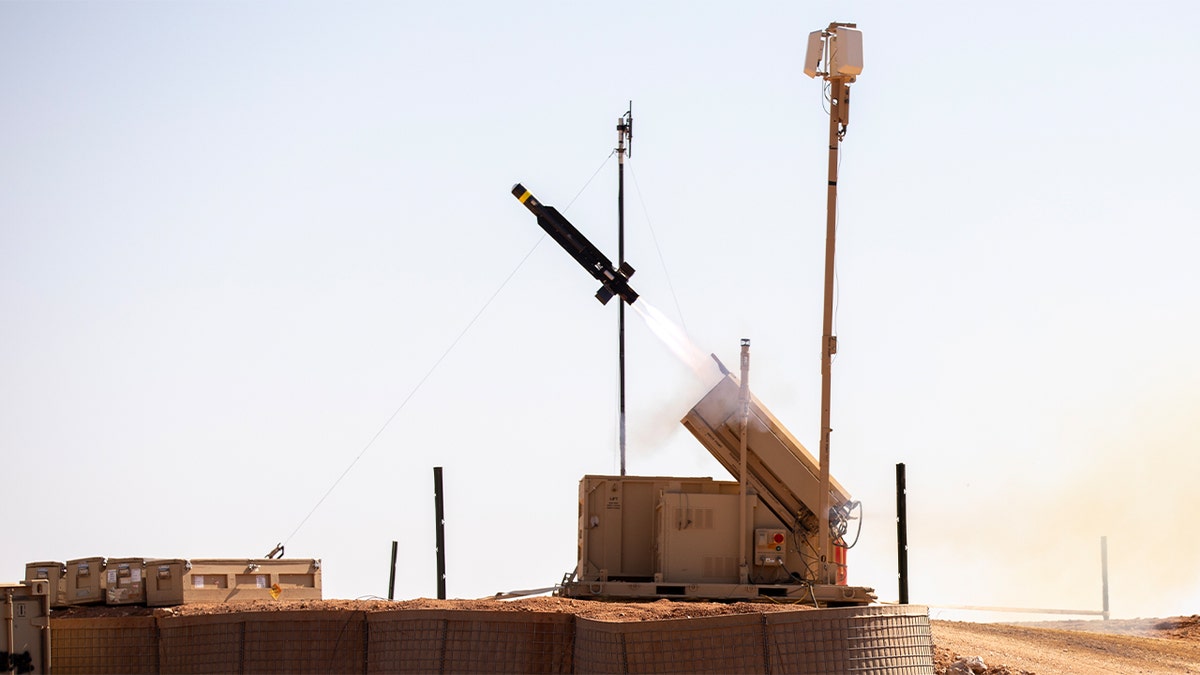 A missile interceptor launches from a ground-based system during a military base defense exercise in Syria.
