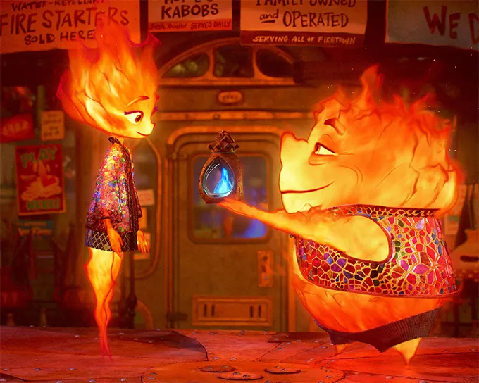 A screencap from the Disney and Pixar movie Elemental. It shows the main character Ember with her father Bernie who are both Fire people.